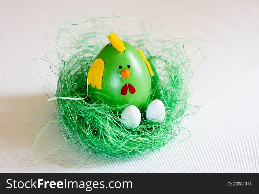 Green chicken with white eggs in a green nest. Easter deoration. Green chicken with white eggs in a green nest. Easter deoration.