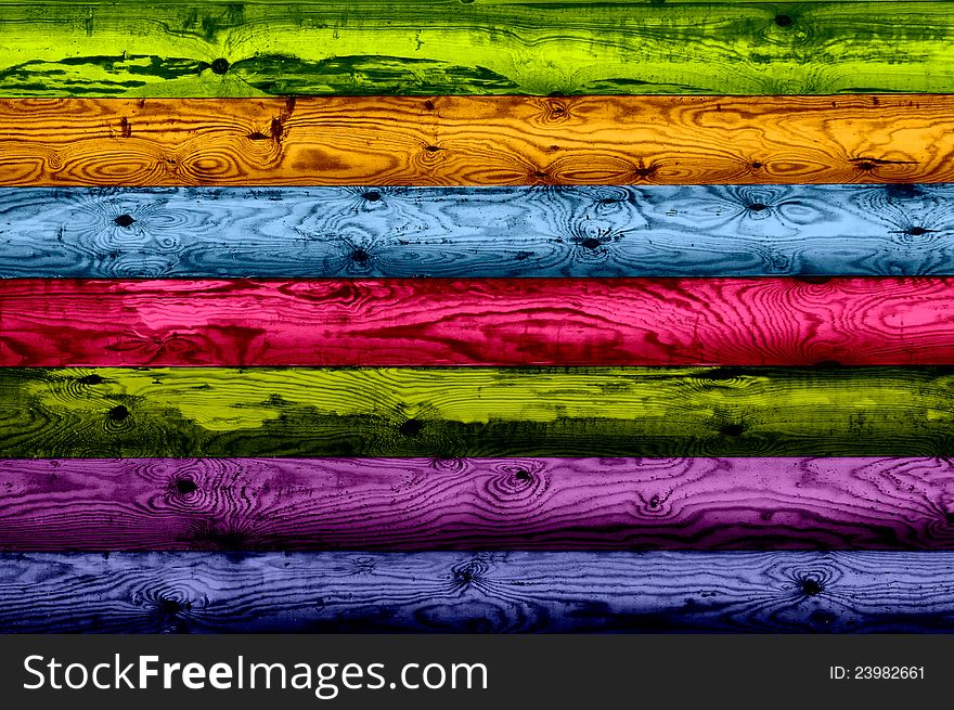 Vibrant multicolored wood planks with beautiful knotted texture as a background - horizontal orientation. Vibrant multicolored wood planks with beautiful knotted texture as a background - horizontal orientation
