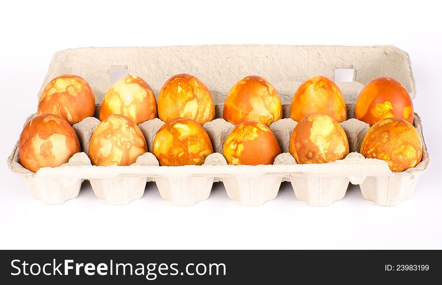 A carton of a 12 naturally dyed golden marbled Easter eggs. A carton of a 12 naturally dyed golden marbled Easter eggs