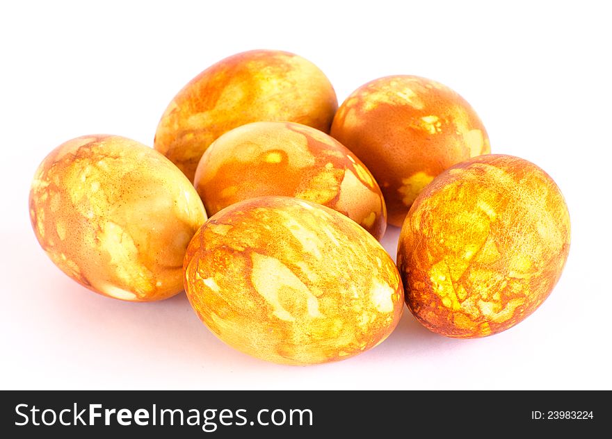 Six naturally dyed golden marbled Easter eggs isolated on white. Six naturally dyed golden marbled Easter eggs isolated on white