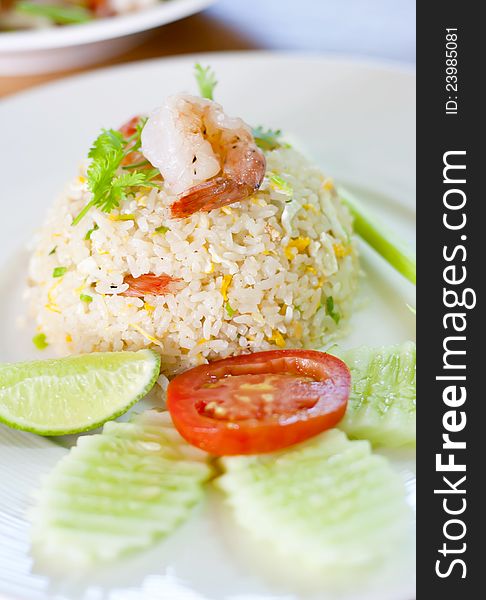 Shrimp fried rice on the dish with vegetables.