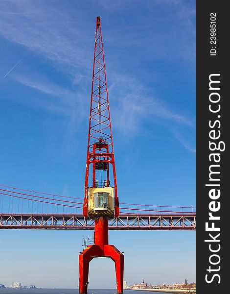 Red crane and red metallic bridge on background