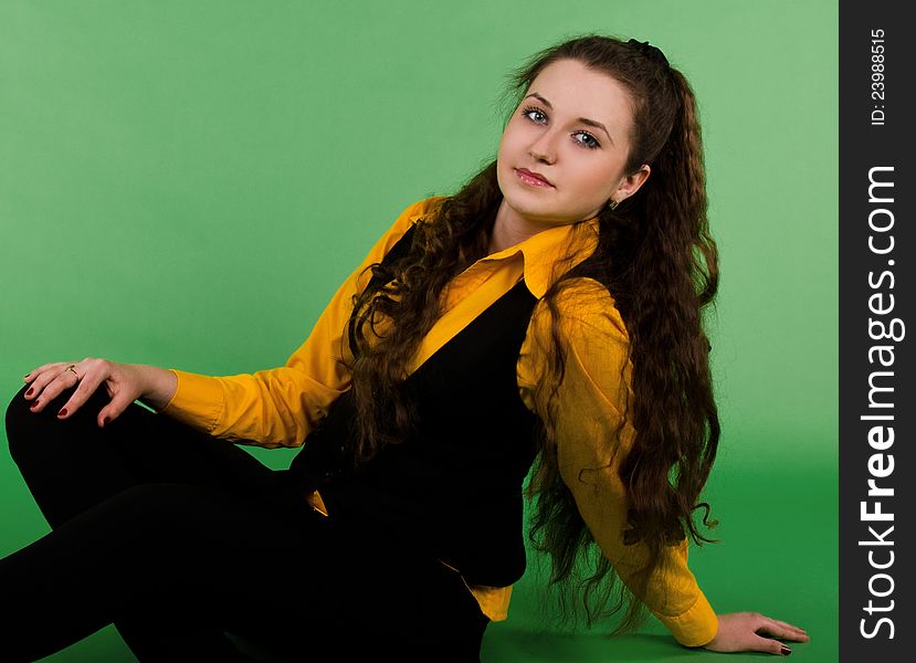 Portrait of sitting beautiful  brunette woman with long hair