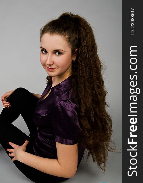 Portrait of sitting beautiful  brunette woman with long hair