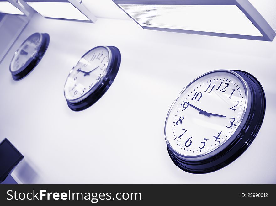 Three wall clocks showing time in different parts of the world in office. Three wall clocks showing time in different parts of the world in office