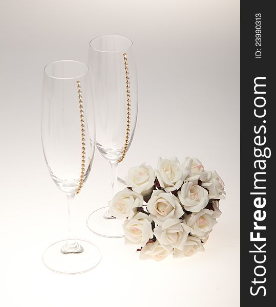 Bouquets and glasses on a white background. A bouquet of white flowers.