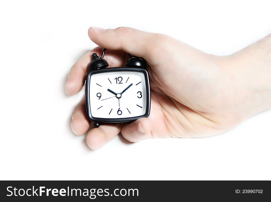 Black clock on white background. In hand. Black clock on white background. In hand