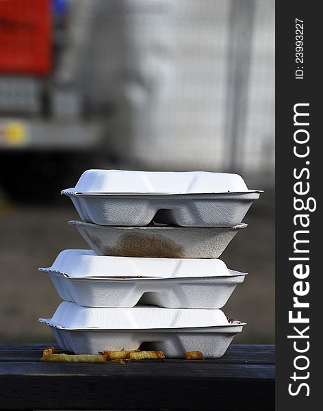 Styrofoam food boxes stand in a stack on a table. Styrofoam food boxes stand in a stack on a table