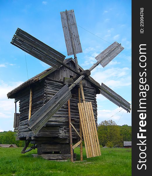 The wooden windmill on meadow