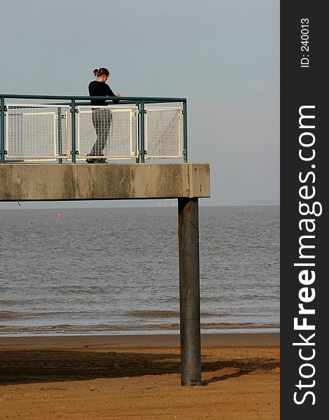 Girl standing at teh end of the pier. Girl standing at teh end of the pier