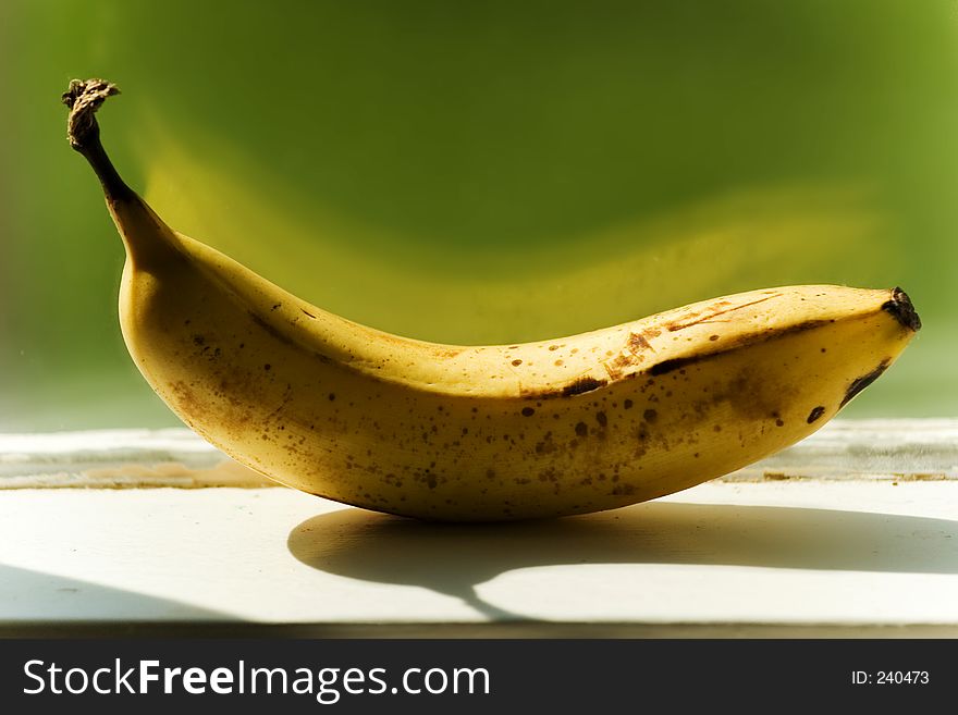 Banana on windowsill in afternoon. Banana on windowsill in afternoon