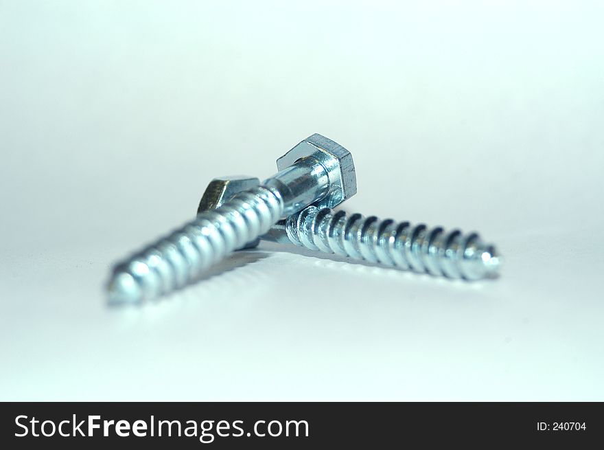 Two bolt lying on top of each other. Isolated from background. Two bolt lying on top of each other. Isolated from background.
