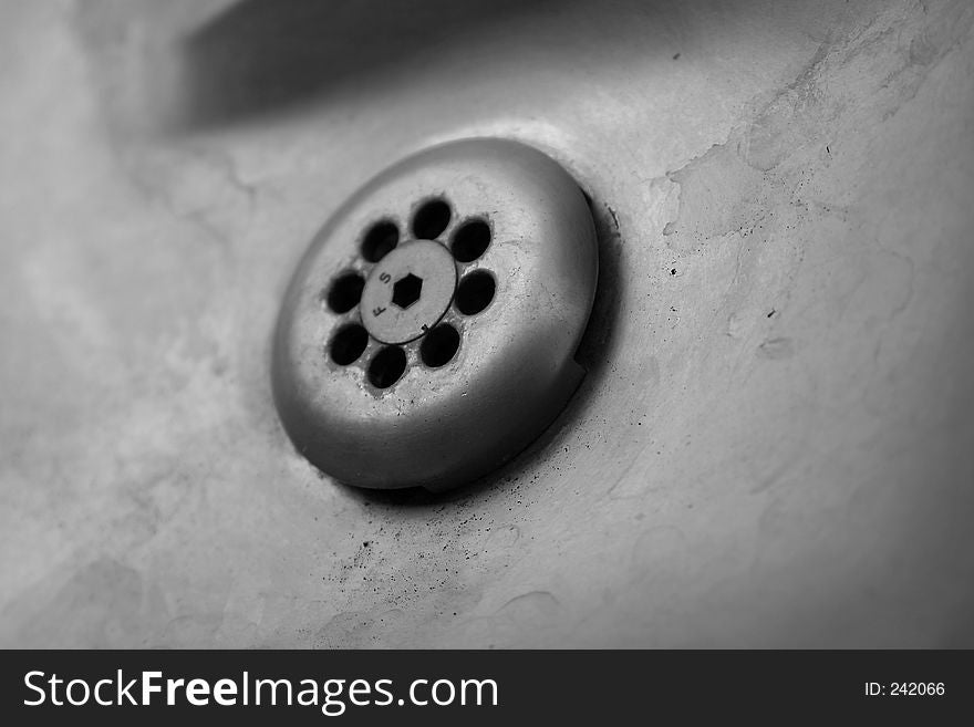 Silver metal drain from a water fountain