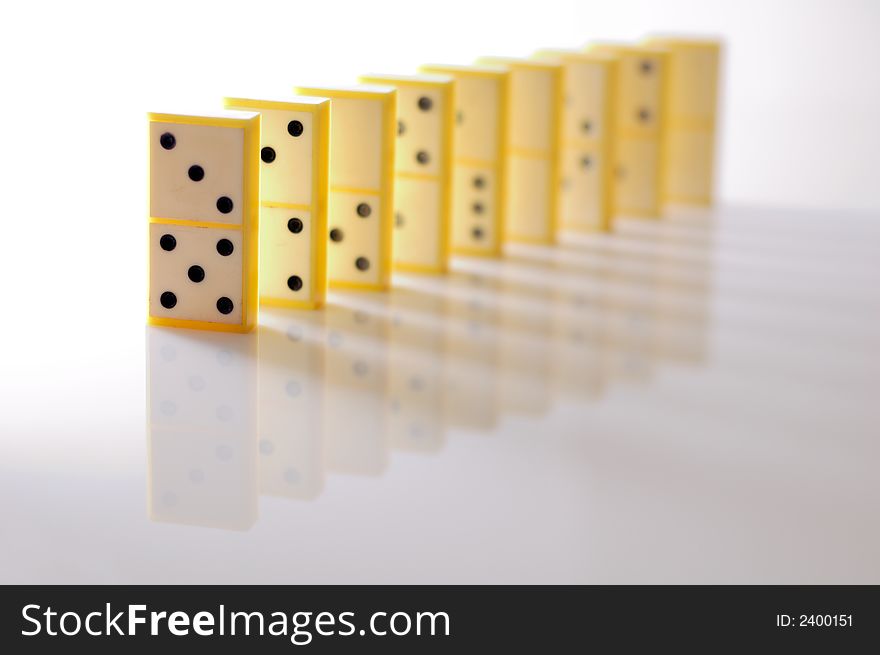 DOmino blocks in a row, illuminated from left