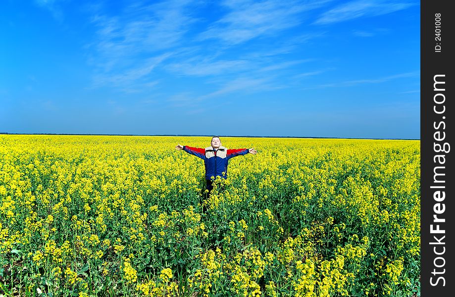 Happy boy on meadow on blue sky background
