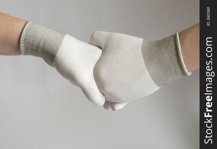 Male and female handshake with gloves