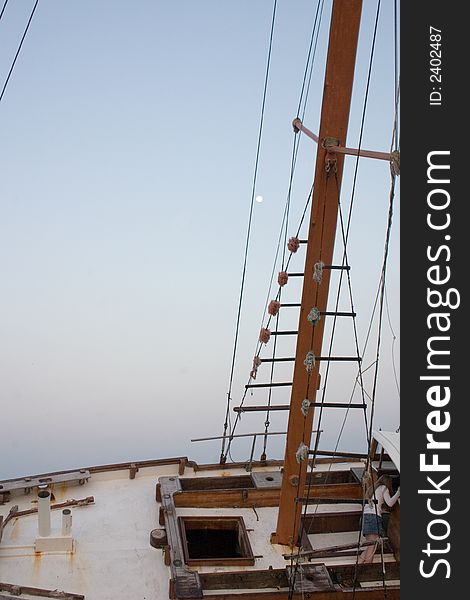 A million dollar sailboat yacht beached and shipwrecked along the East coast of Florida in the Ocean. Shown at moonrise. A million dollar sailboat yacht beached and shipwrecked along the East coast of Florida in the Ocean. Shown at moonrise