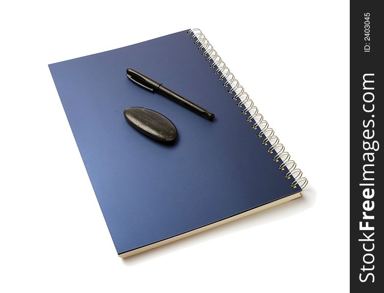 Organizer and pen and black pebble isolated over white background. Organizer and pen and black pebble isolated over white background