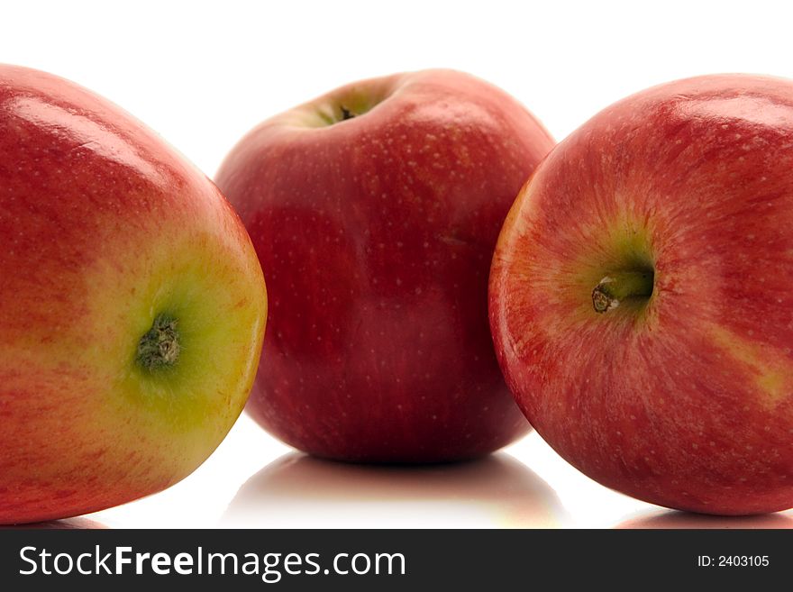 Tree red apples over white background