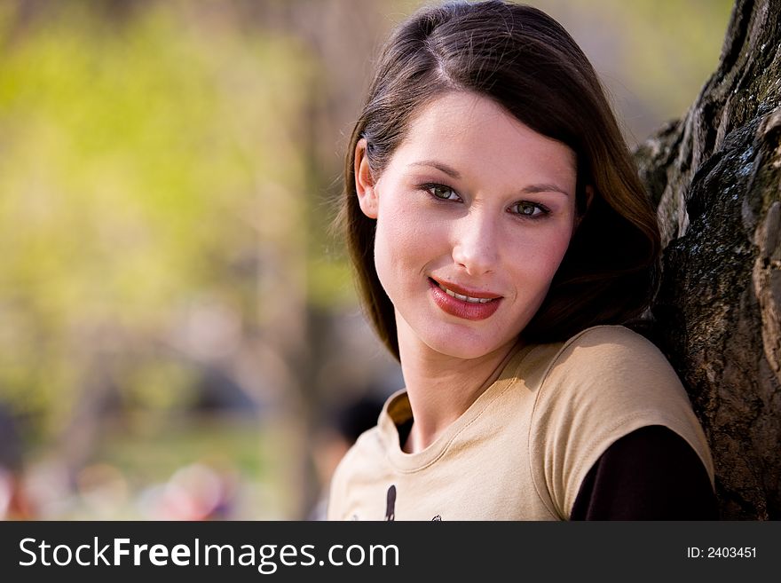 Beautiful young woman in nature looks amorous