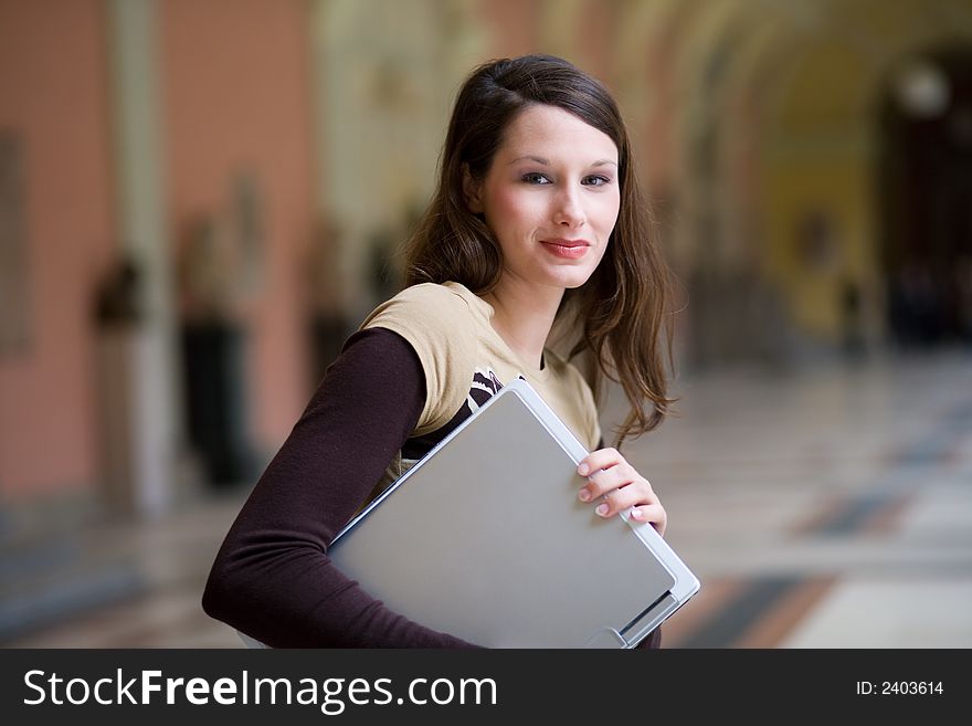 Young woman with her notebook on the way to the lecture