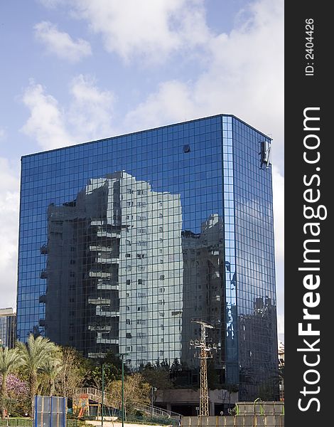 Glass tower with reflection of building