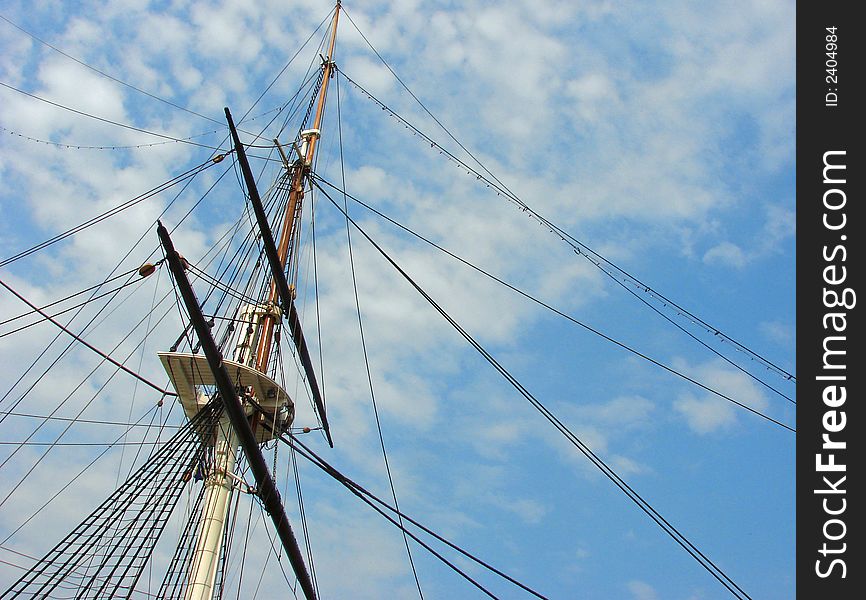 Mast of a ship pointing up through blue skies. Mast of a ship pointing up through blue skies.