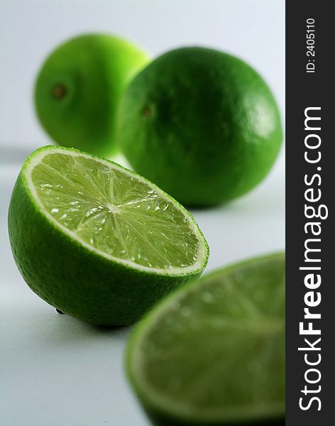 Two and a half limes on a light background, limited depth of field. Two and a half limes on a light background, limited depth of field