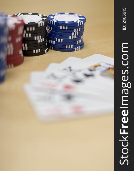 A Hand of Cards lie together on a wooden table. A Hand of Cards lie together on a wooden table