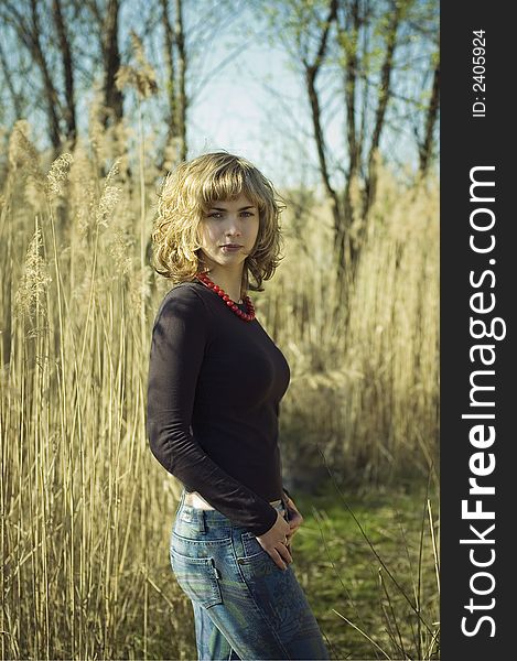 Blond standing behind a reed