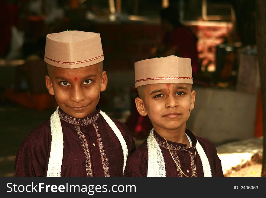 Smart village boys appearing for a thread ceremony with caps and traditional dress.