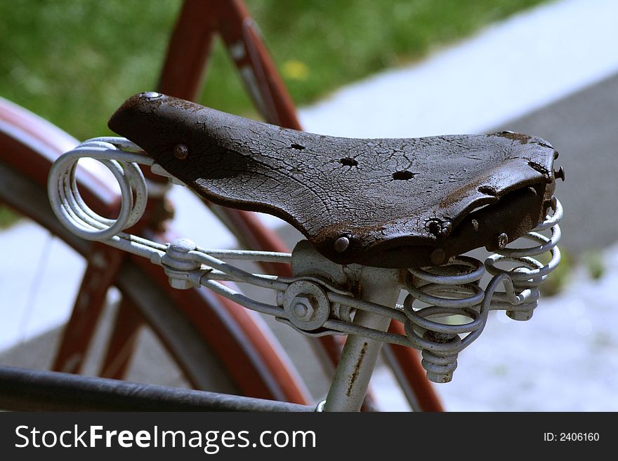 Old leather saddle with spiral spring