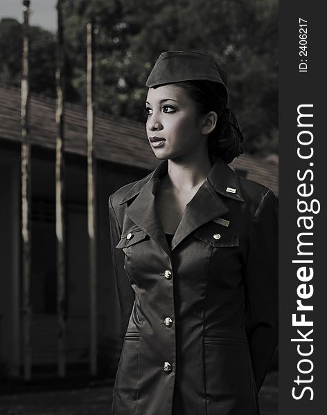 Female Army Personnel in an old barrack looking in a direction in vintage feel