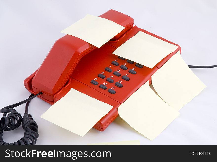 Red telephone with yellow memo paper. Red telephone with yellow memo paper