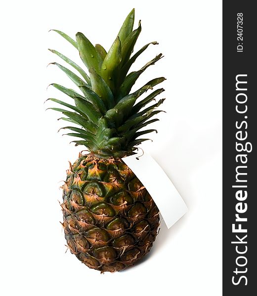 Close-up of pineapple with blank tag isolated on white. Close-up of pineapple with blank tag isolated on white