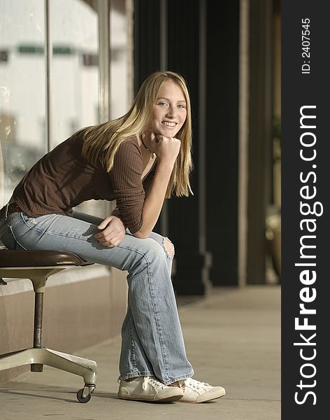 A college age female finds a place to sit outside a downtown business in a small Texas town. A college age female finds a place to sit outside a downtown business in a small Texas town.