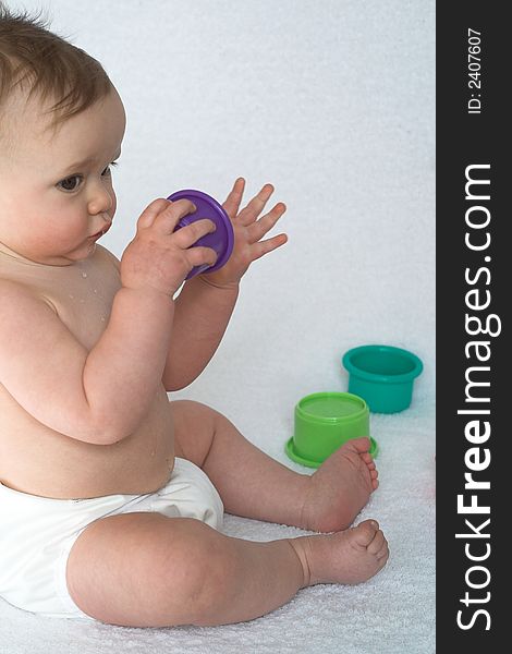 Image of adorable baby playing with stacking cups. Image of adorable baby playing with stacking cups