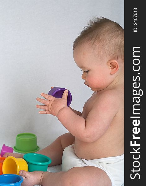 Image of adorable baby playing with stacking cups. Image of adorable baby playing with stacking cups