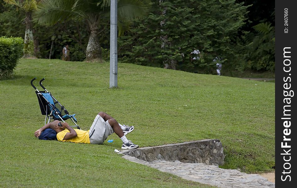 Man on the mobile phone taking a rest in a park. Man on the mobile phone taking a rest in a park