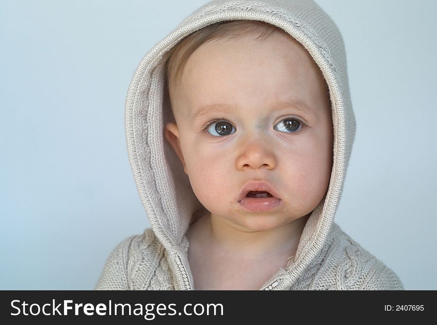 Image of cute baby wearing a hooded sweater. Image of cute baby wearing a hooded sweater