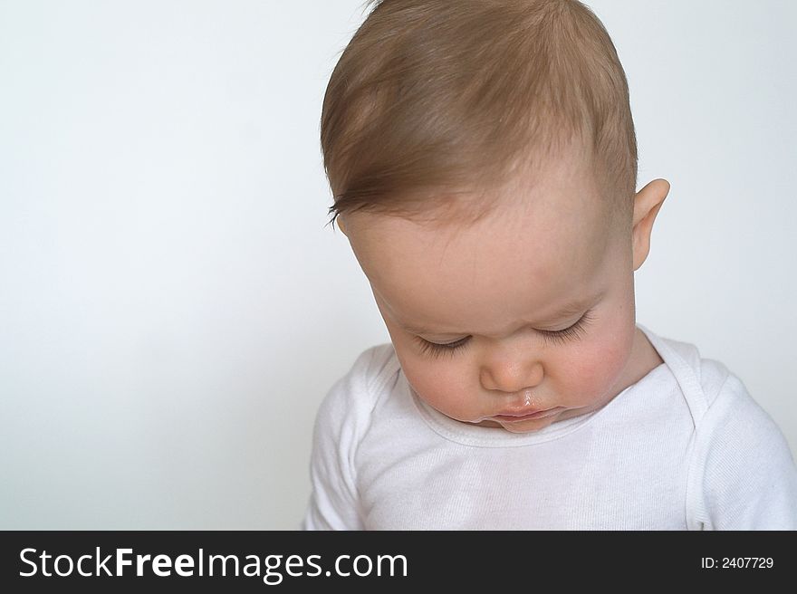 Image of a beautiful baby looking down so his eyelashes are visible. Image of a beautiful baby looking down so his eyelashes are visible