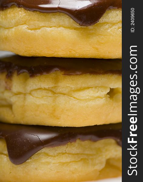 Close up of three boston creme donuts stacked isolated on white. Close up of three boston creme donuts stacked isolated on white