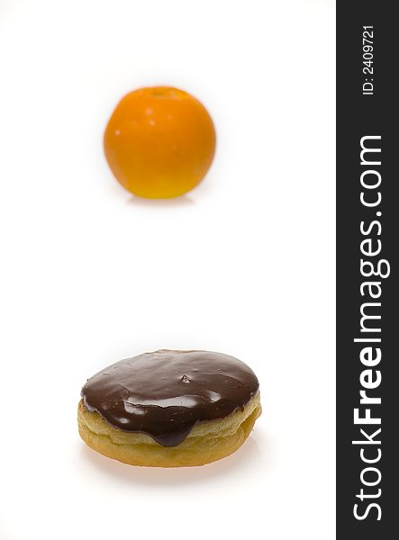 Chocolate donut and an orange isolated on whtie. Chocolate donut and an orange isolated on whtie