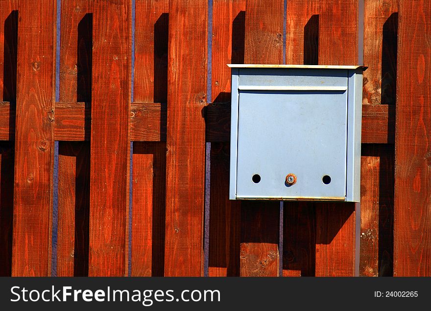 Mail box fixed on a wooden background