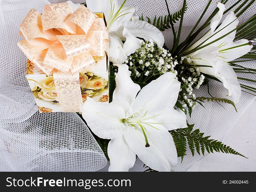 Bouquet of lilies with a gift