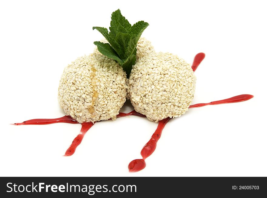 Balls of ice cream with sesame seeds on a white background