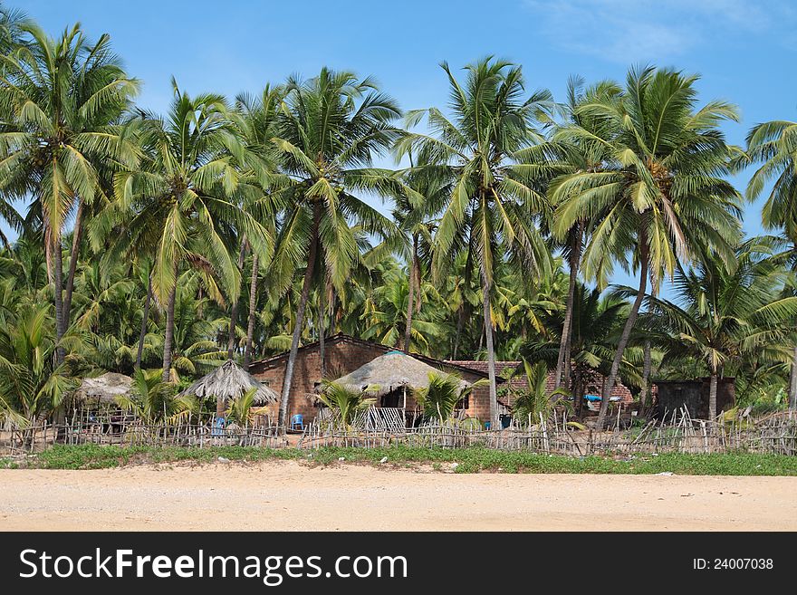 Beautiful view of beach, summer houses and palm trees in Polem, Goa, India. Beautiful view of beach, summer houses and palm trees in Polem, Goa, India