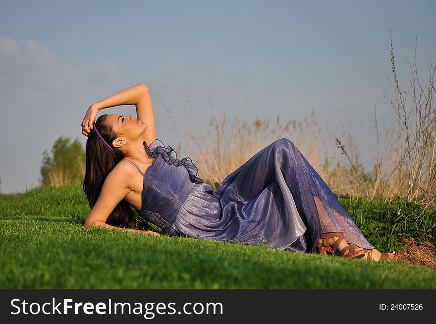 Beautiful Girl Laying On A Grass
