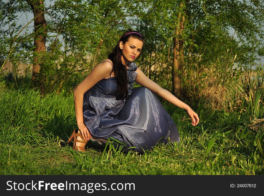 Portrait of the beautiful woman in the forest