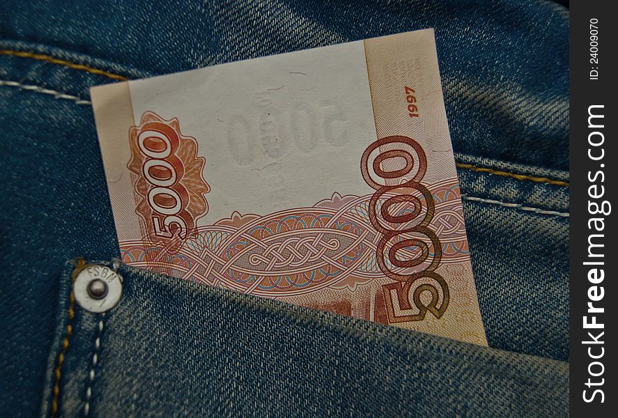 5000 rubles banknote in a blue jeans pocket